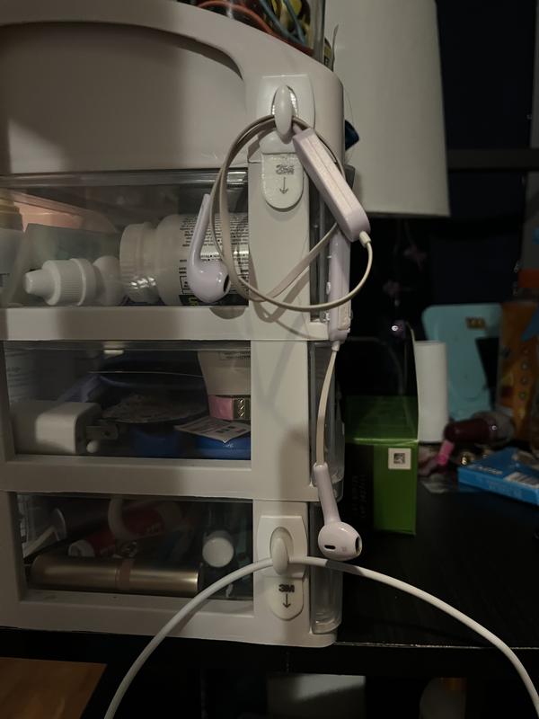I use the mini hooks on my bedside table to hold my earbuds and my phone charger
