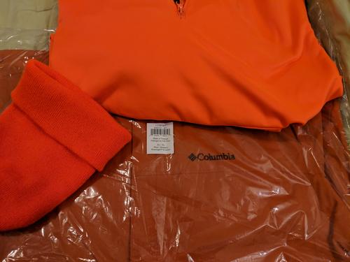 Backcountry Orange jacket near hunter orange hat and sweatshi