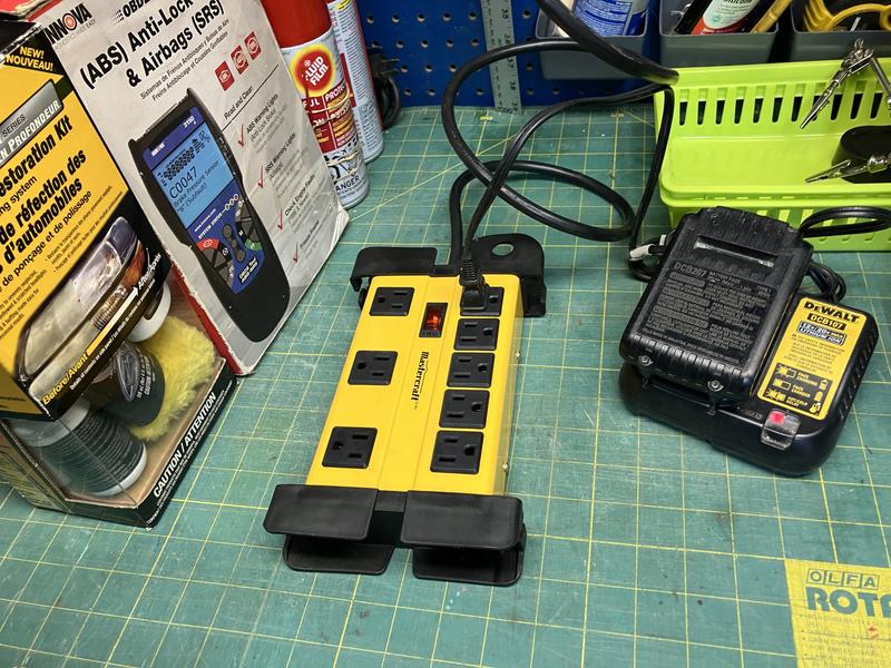 Power bar plugged into ceiling receptacle.