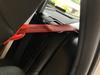 How the red guide on the booster seat pulls the car seat belt out and across it’s housing, stopping it from working properly.