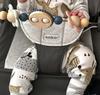 Loves his Baby Bjorn toy bar