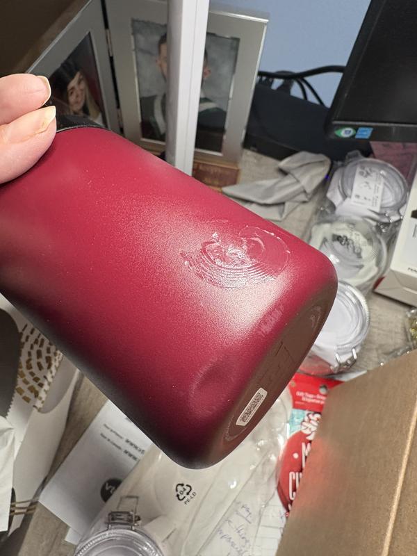 Small dent on bottom and stubborn sticker residue.