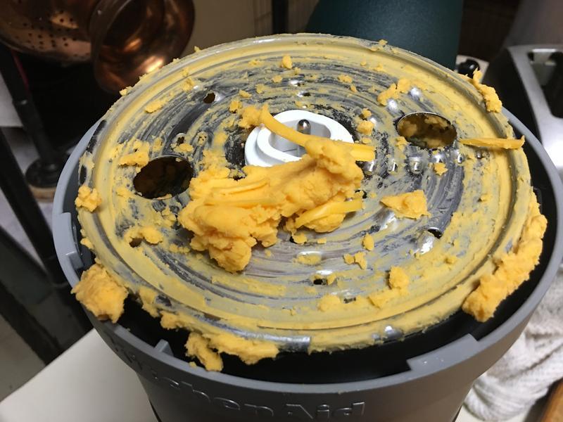 Grating disk with clump of cheese from bowl