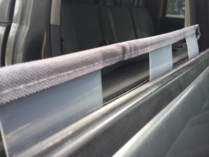 Tabs slide in the door next to the window.