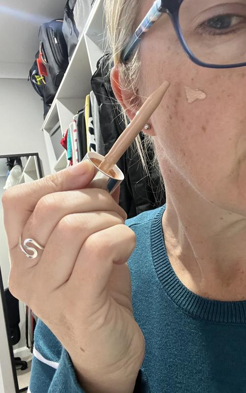 Applying serum to cheek