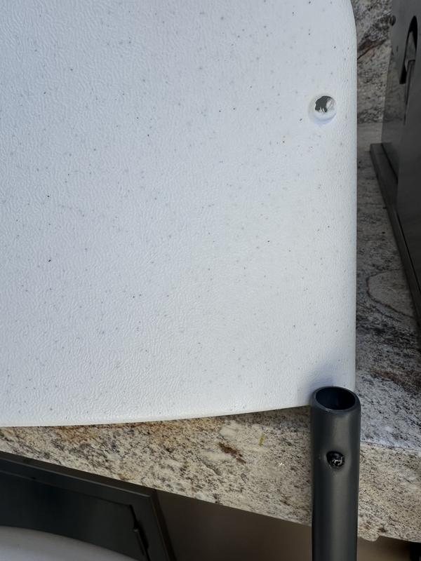 The photo on the right shows the back of the chair off and the screw still in the support.