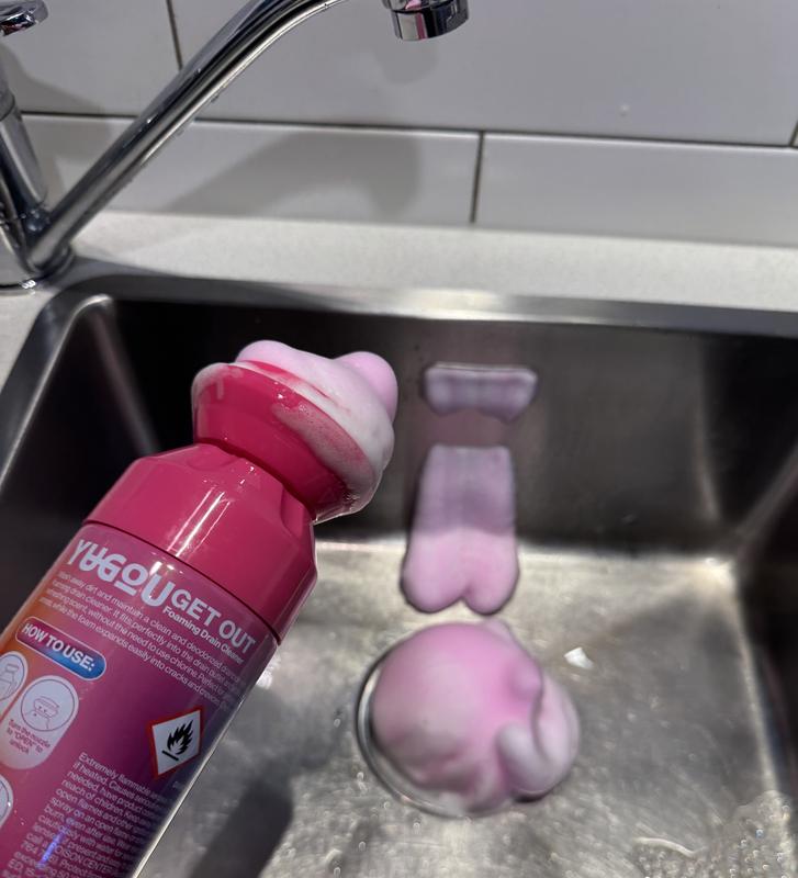 Pink expanding drain cleaner foam in a stainless steel sink