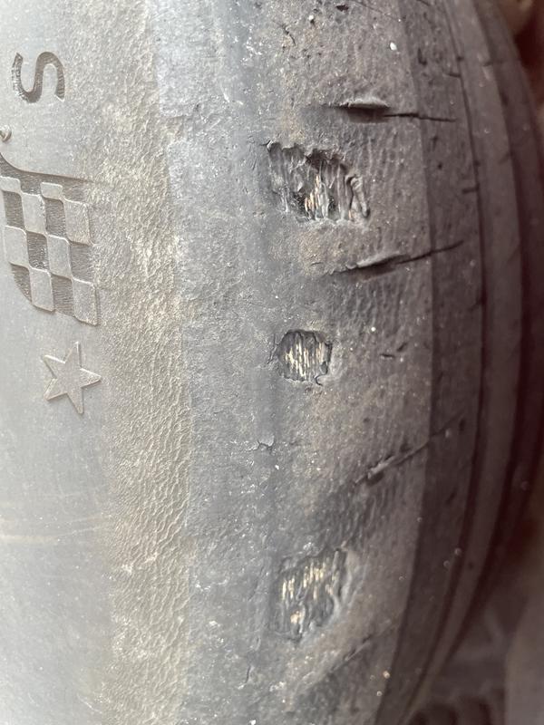 Chunk of rubber missing. Cord showing through.