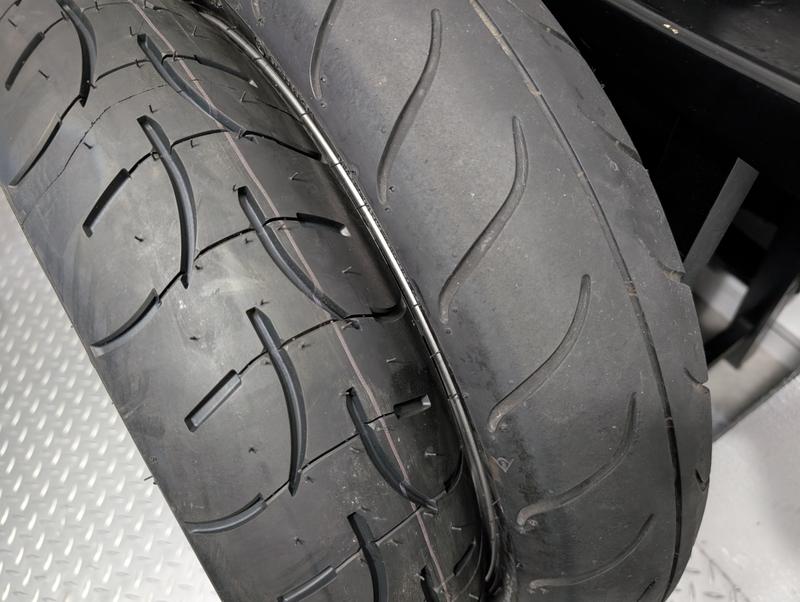 New Michelin (front tire) next to original Dunlop (6,500k miles).  Huge difference.