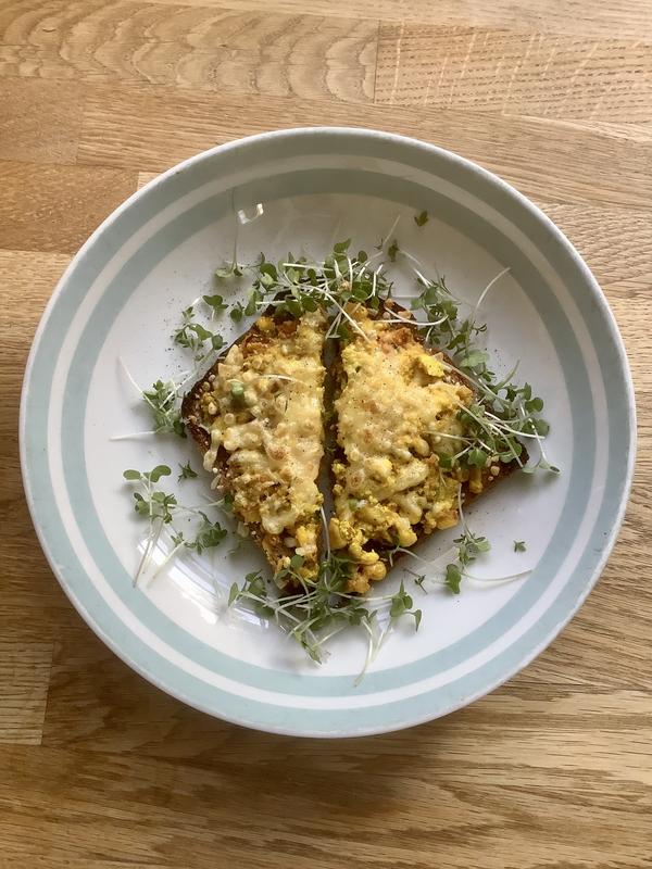 Scrambled tofu on toast, grilled with vegan cheese shreds