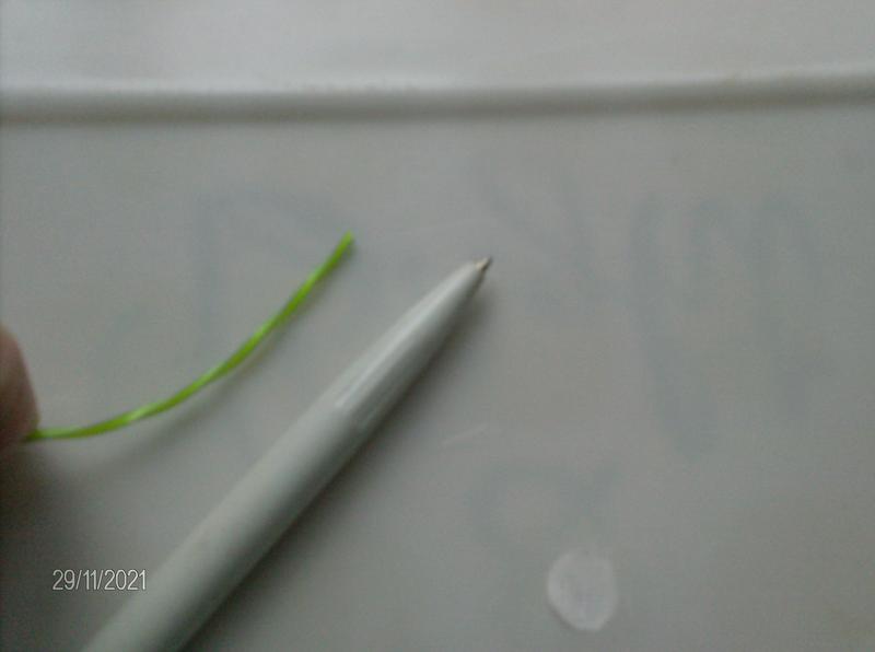 Actual cord showing size next to regular writing pen.