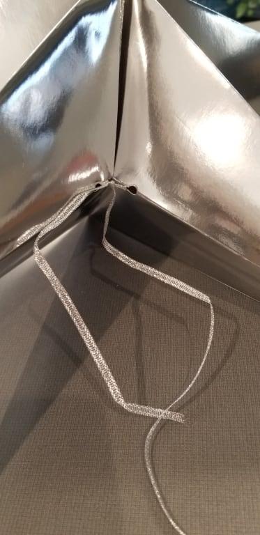 strings hangs out and tears holes to secure star