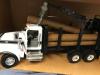 Truck side view with doors open and log picked up