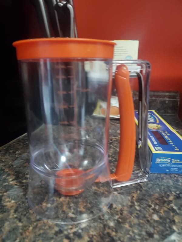 The batter dispenser is 900ml it holds up to 4 cups of mix.. i like it because all you do is squeeze the handle to control it. Smile