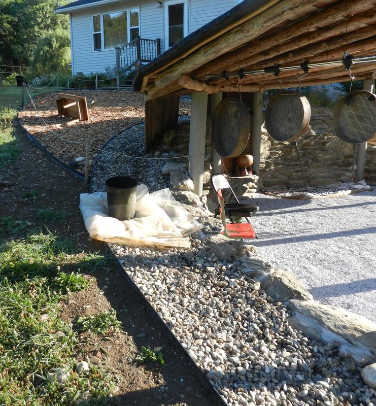 Edging lined with stone covered vinyl for drip edge.