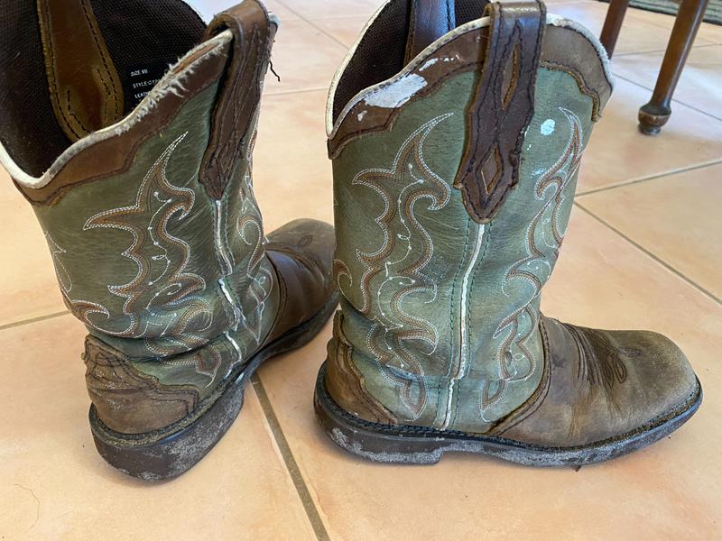 Here is a photo of her latest pair after having been worn daily for a year.  No holes, but certainly enough dirt and paint on them.  Also no holes in these yet!